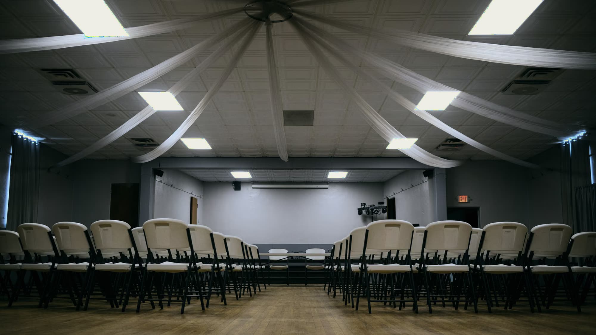 Empty function hall, chairs lined up facing a stage